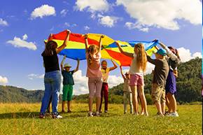 children playing with a parachute